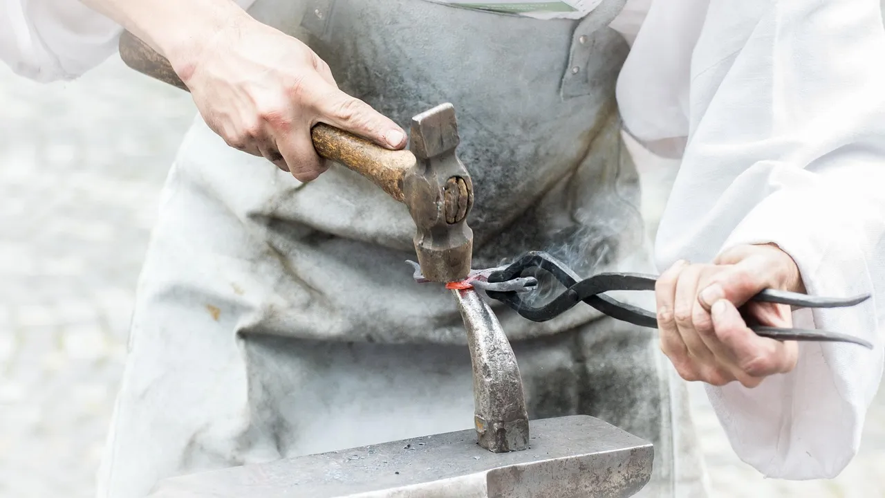 Artisan forgeron travaillant le métal à l'enclume